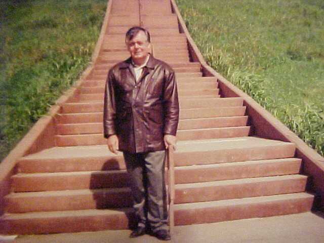 Daniel Bierman standing on the steps of the Monk Mound located in Cahokia Il.
